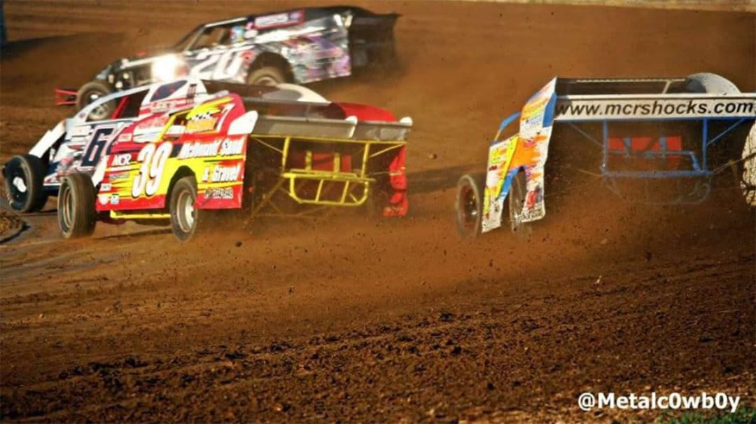 dirt with four race cars all in different directions